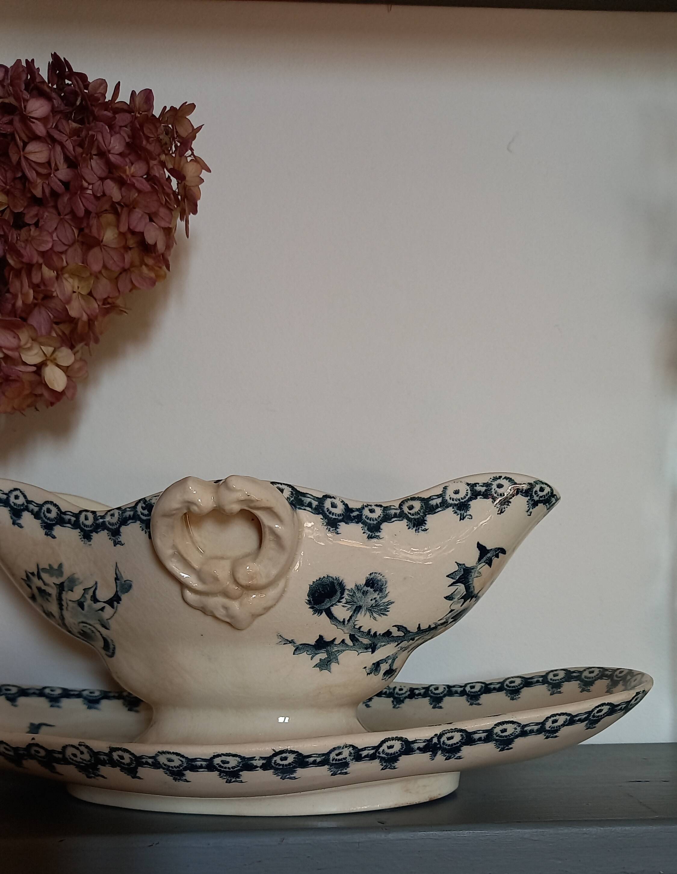 Old gravy boat on frame in terre de fer earthenware by gien, “chardons” model in blue-green