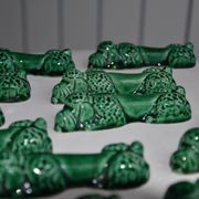 12 green earthenware knife rests