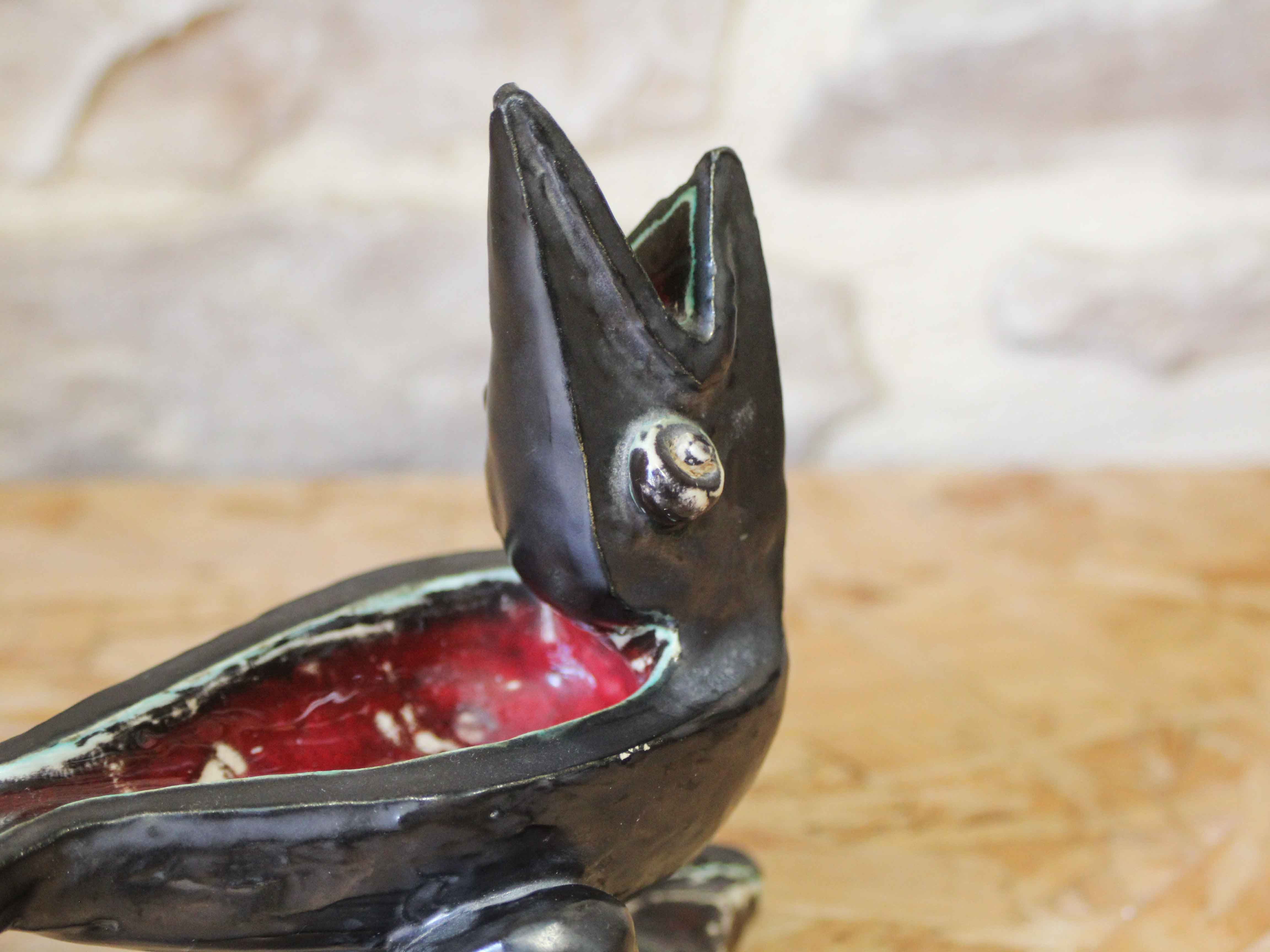 Glazed ceramic ashtray in the shape of a bird.