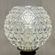 Antique brass foot lamp with glass globe and diamond point.