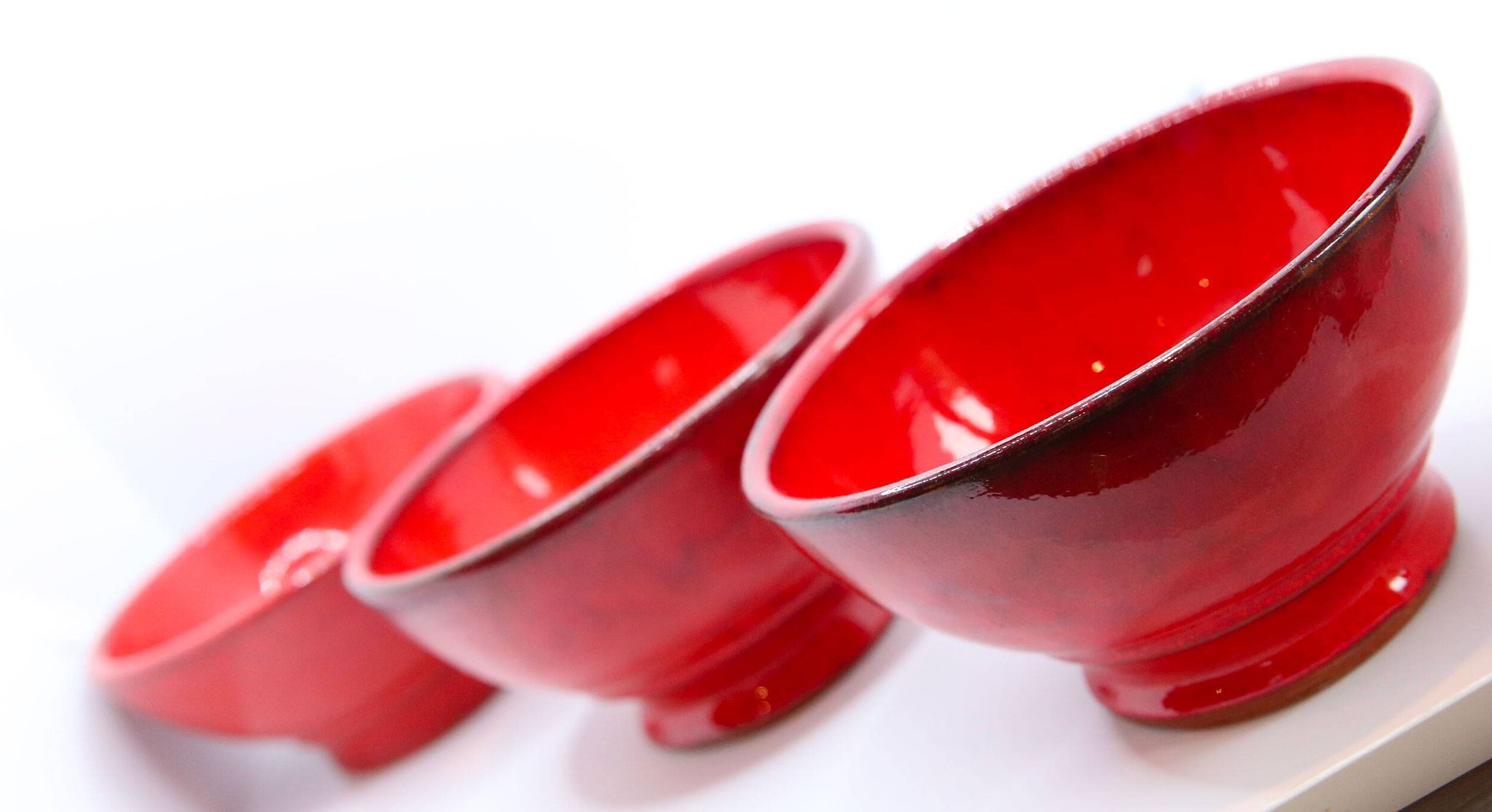 Set of 3 bright red enamelled earth bowls made in France