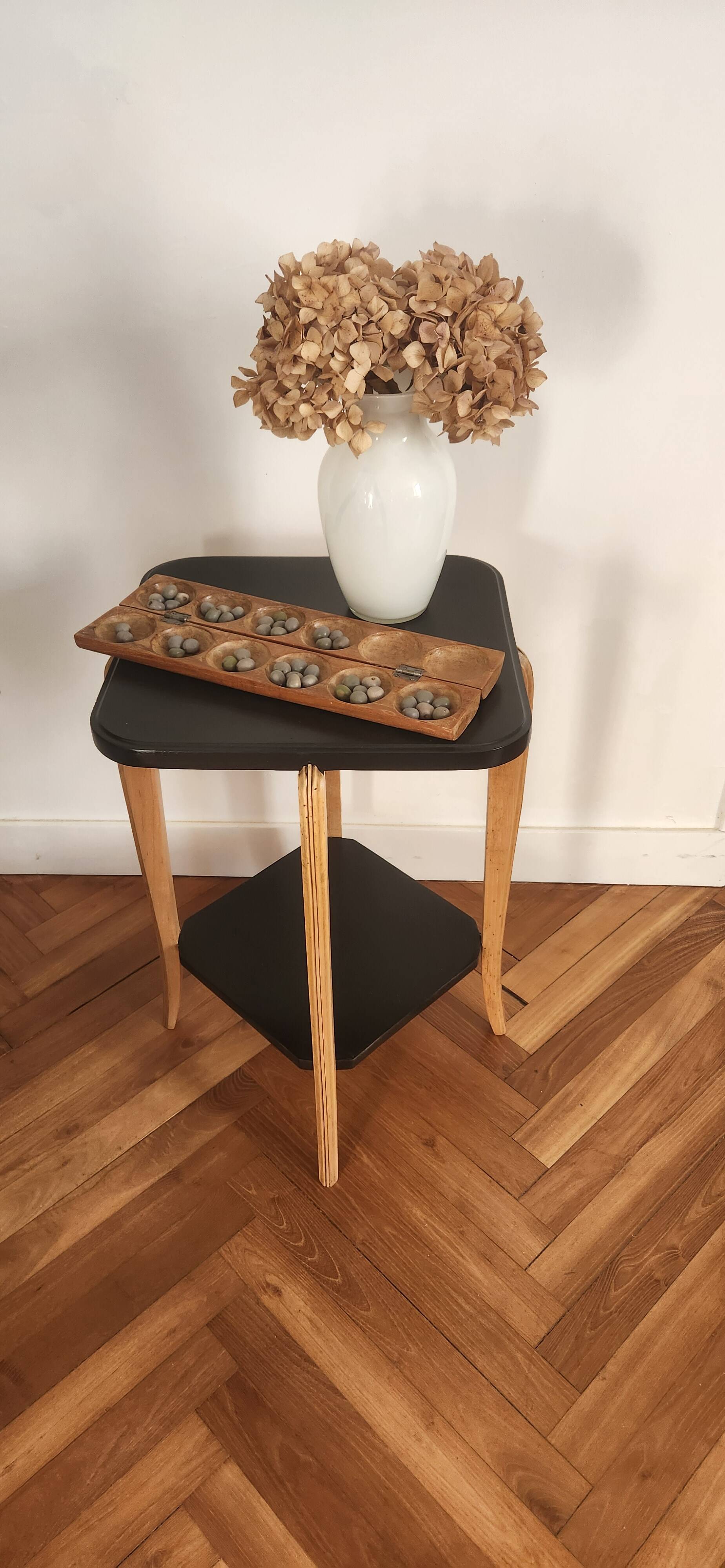 Black lacquered wooden side table with offset tops.