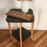 Black lacquered wooden side table with offset tops.