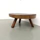 Brutalist coffee table in solid teak, monolithic slab, tripod base.