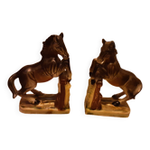 Ceramic bookends with slip decoration featuring horses.