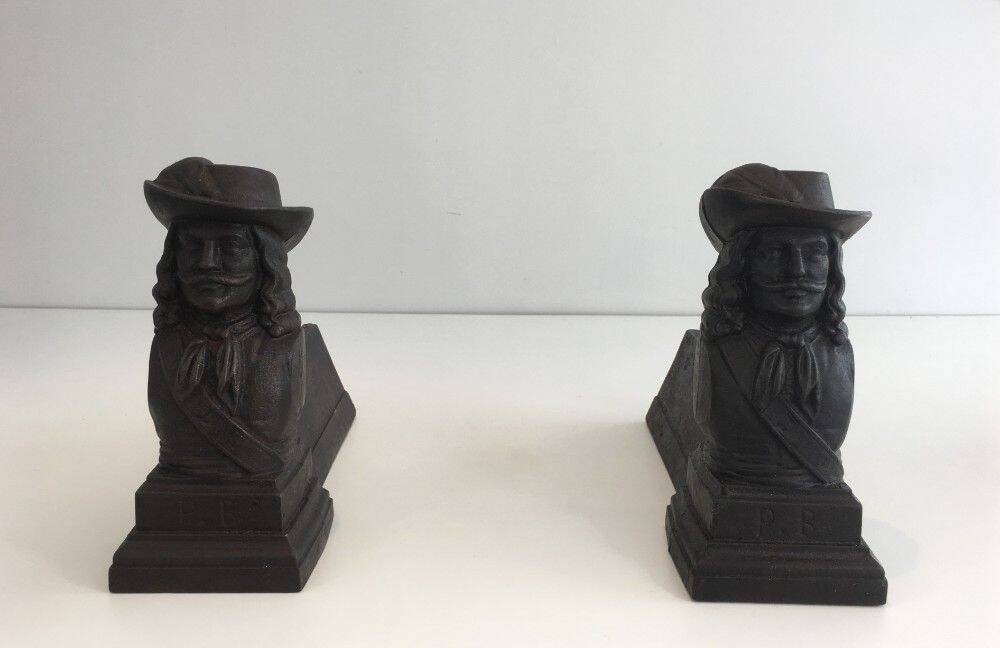 Pair of cast iron andirons in the likeness of a musketeer