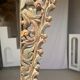 Indonesian construction element in carved wood with intertwined plant motifs mounted on a base (fri