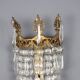 Antique wall sconces in gilded bronze with neoclassical motifs, 20th century.