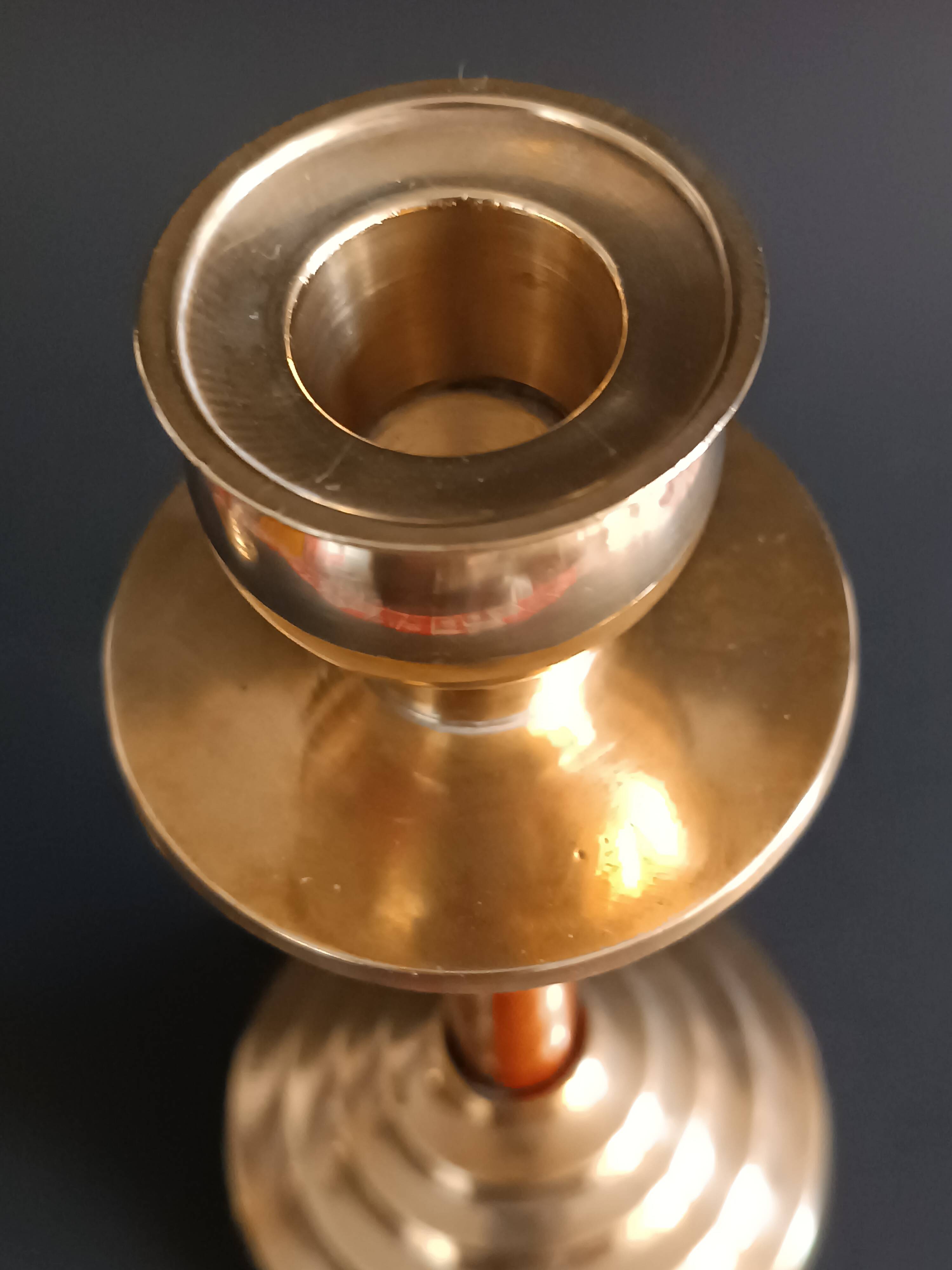 Two vintage wooden and brass candlesticks.