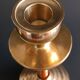 Two vintage wooden and brass candlesticks.