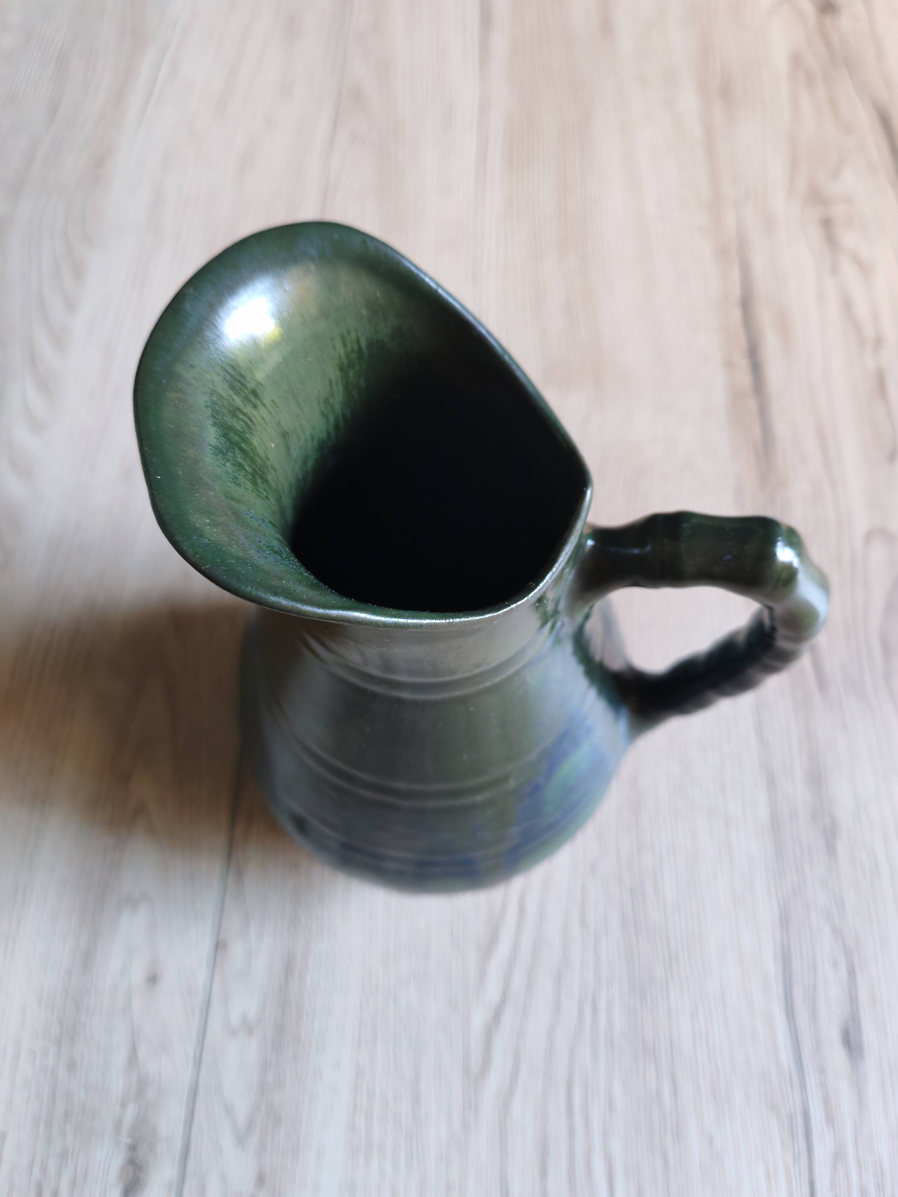 Vintage ceramic pitcher vase in glazed green and blue.