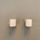 Wall lamps with milky white acrylic plastic shades and solid brass bases