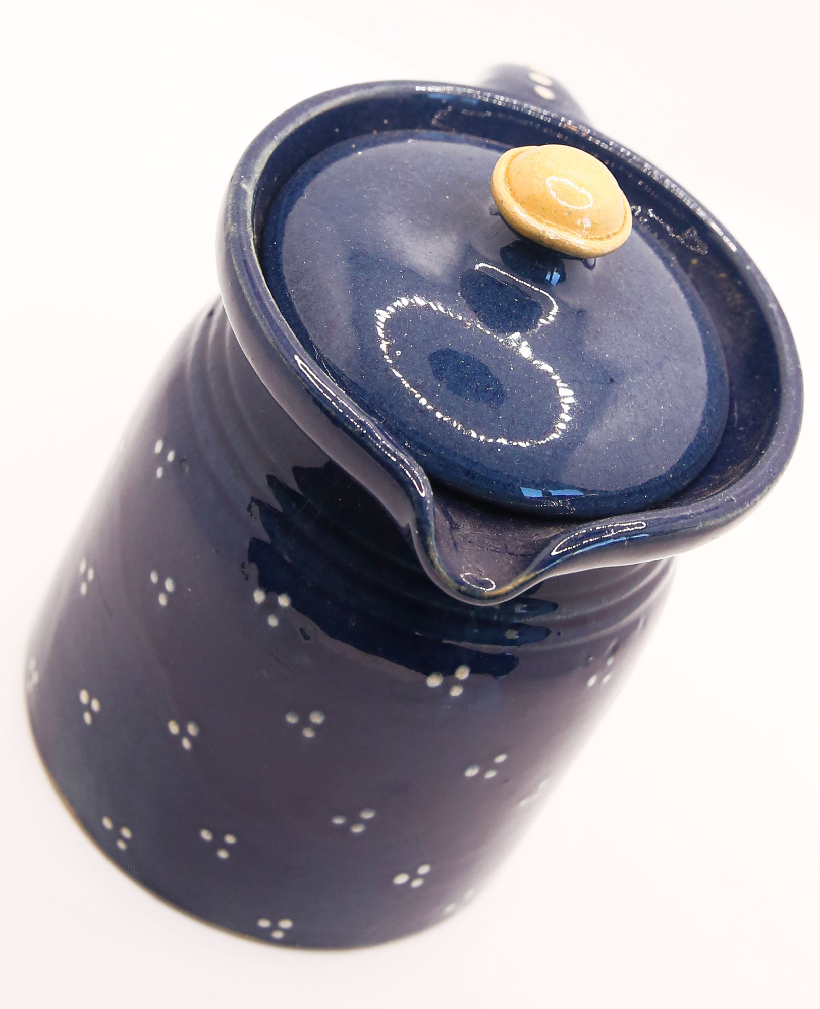 Pitcher and navy blue lid with off-white peas