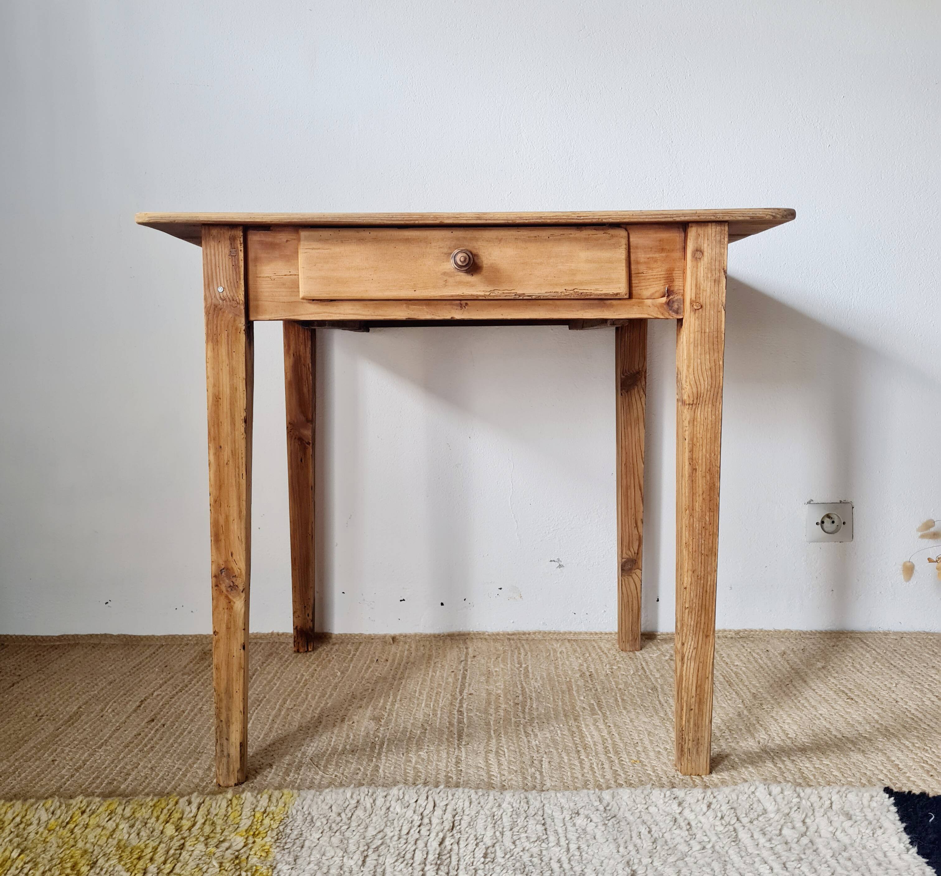 Small old farmhouse table in raw wood.