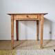 Small old farmhouse table in raw wood.