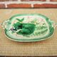 Old square plate in slipware with plant decoration.