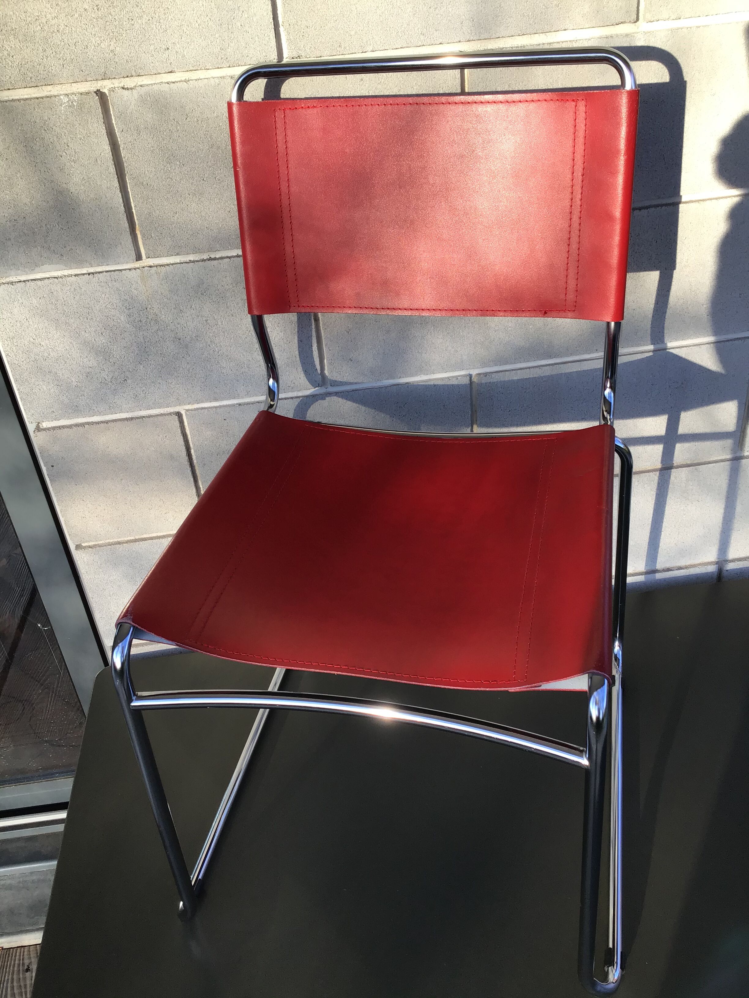 Chrome sled chair and red leather
