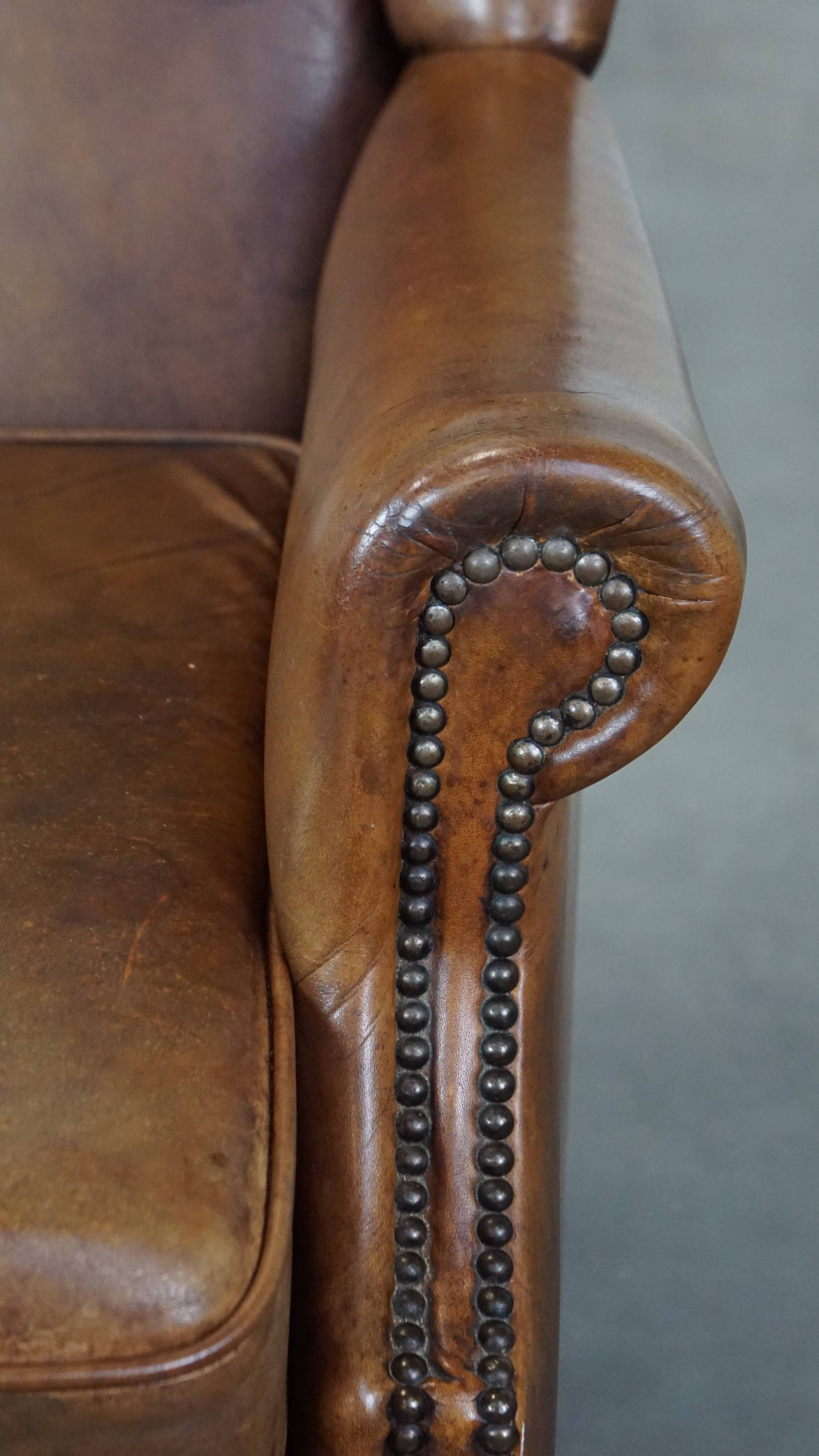 Charming sheep leather wingback armchair with a beautiful patina and excellent seating comfort