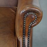 Charming sheep leather wingback armchair with a beautiful patina and excellent seating comfort