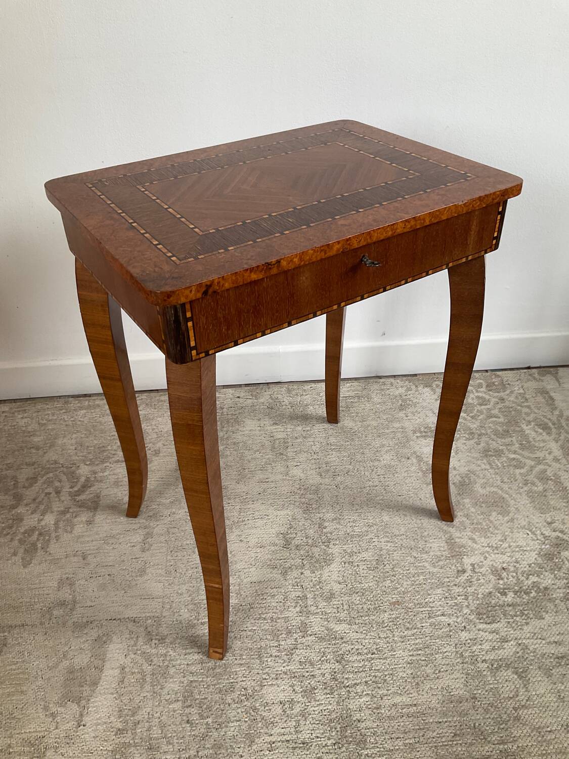 Small marquetry pedestal table with key storage