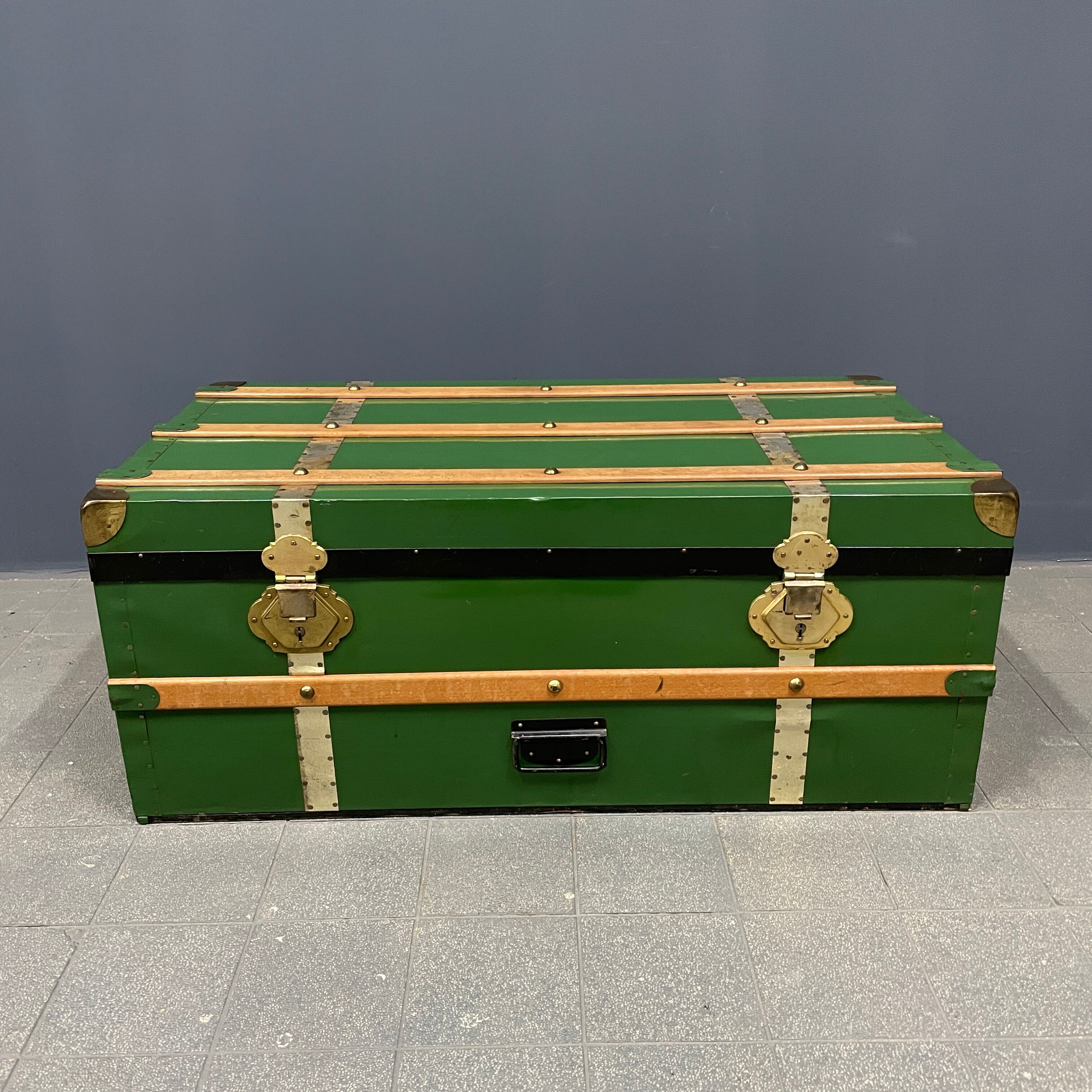 Green metal trunk with wooden sleds