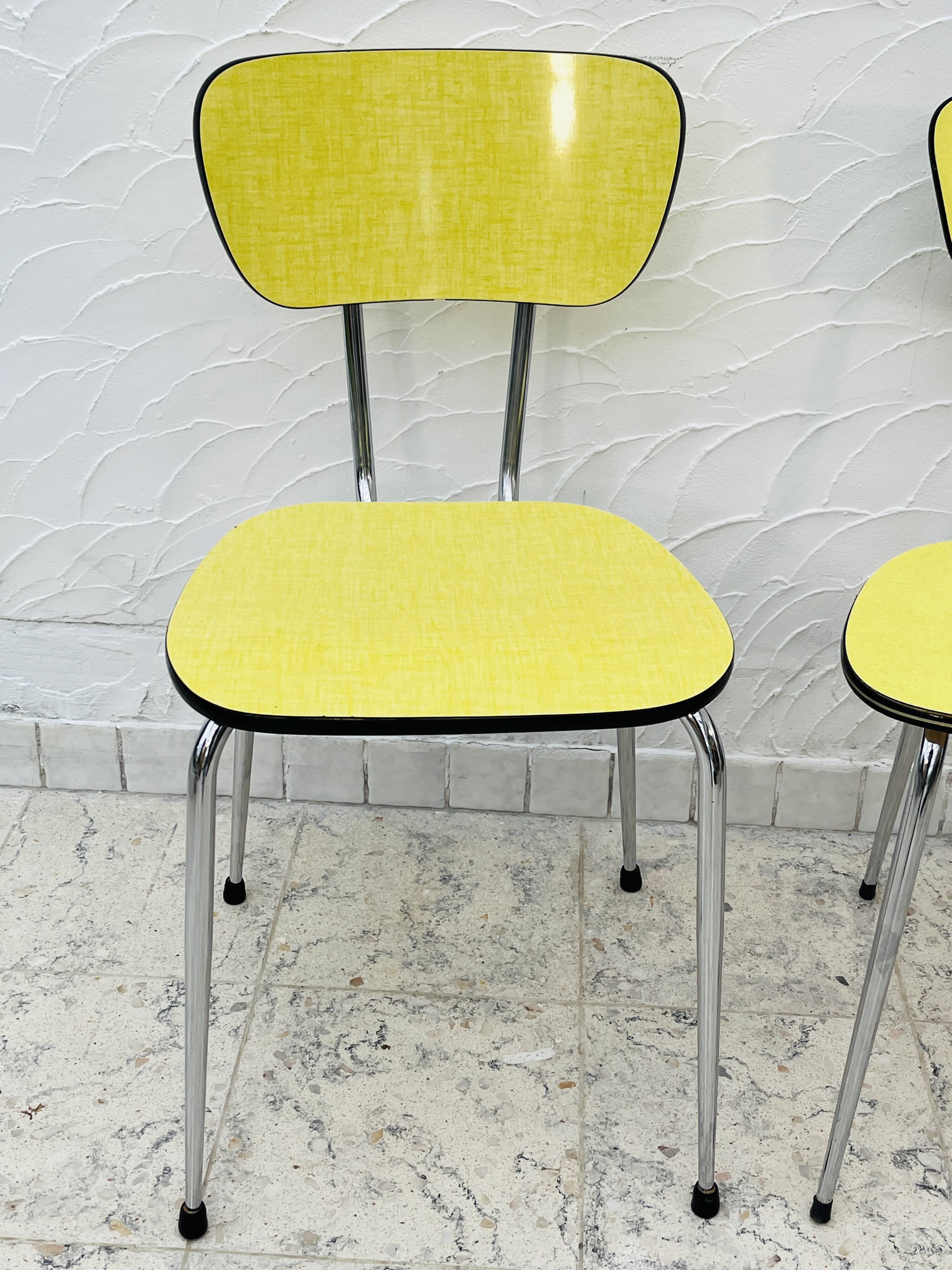 Pair of vintage yellow chrome Formica kitchen chairs.