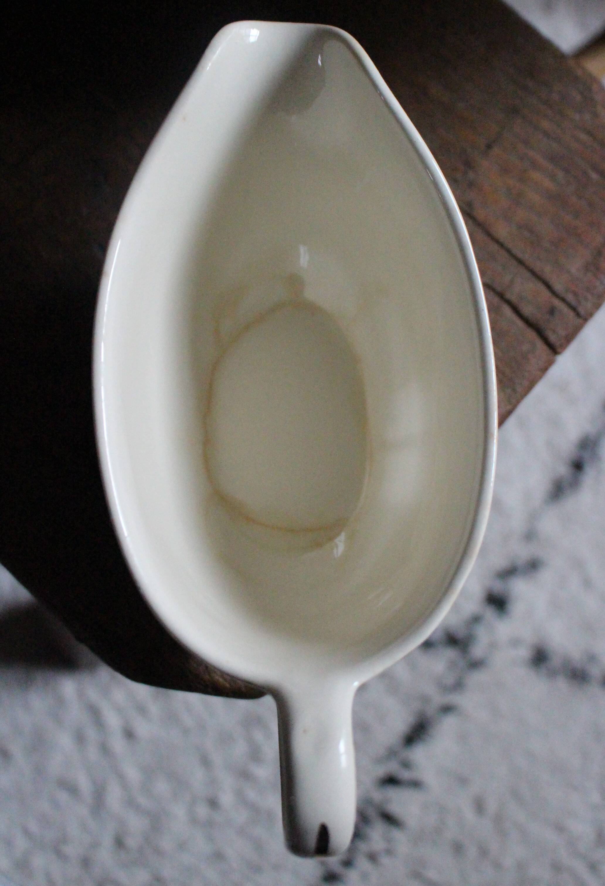 Ecru earthenware gravy boat with gilt trim by Villeroy & Boch