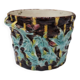 Old earthenware pot with ivy decoration.