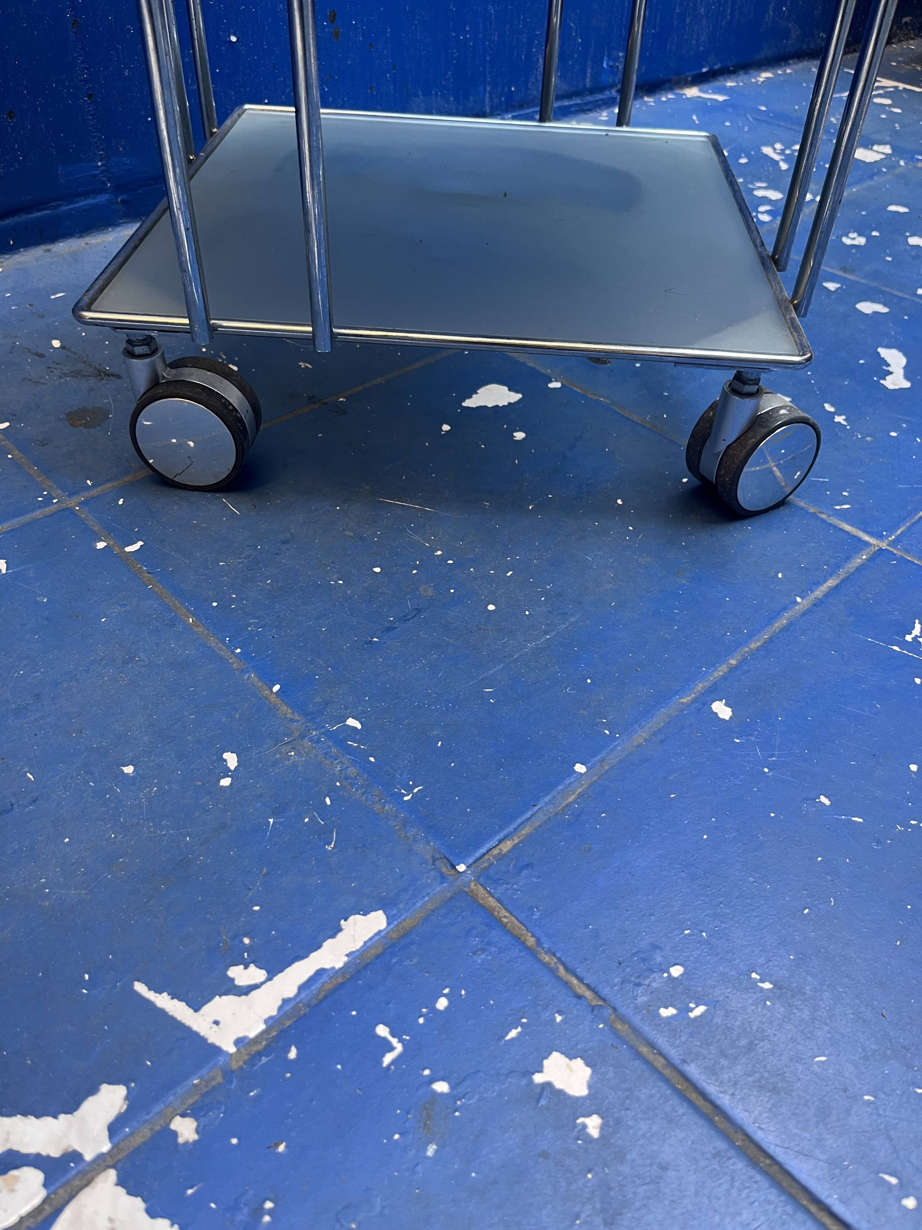 chrome and glass shelving unit on wheels from the 90s