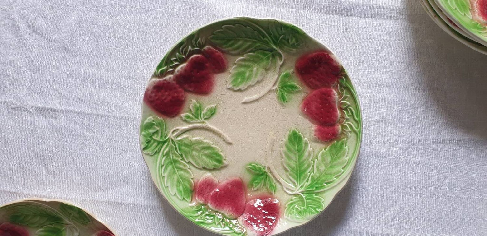 Six assiettes en barbotine décor fraises
