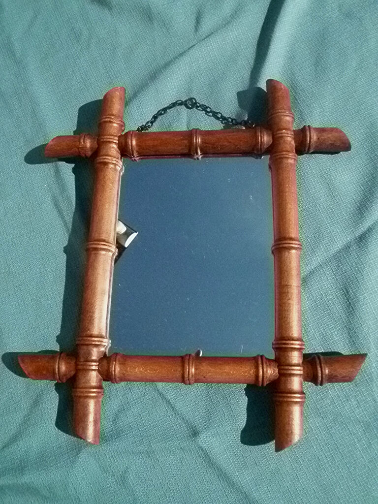 Old wooden mirror, carved bamboo way