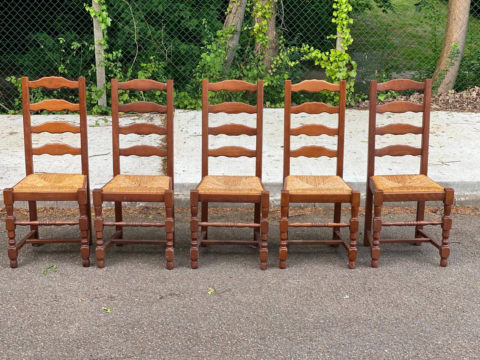 4 or 5 solid wood chairs with light oak straw and high backs