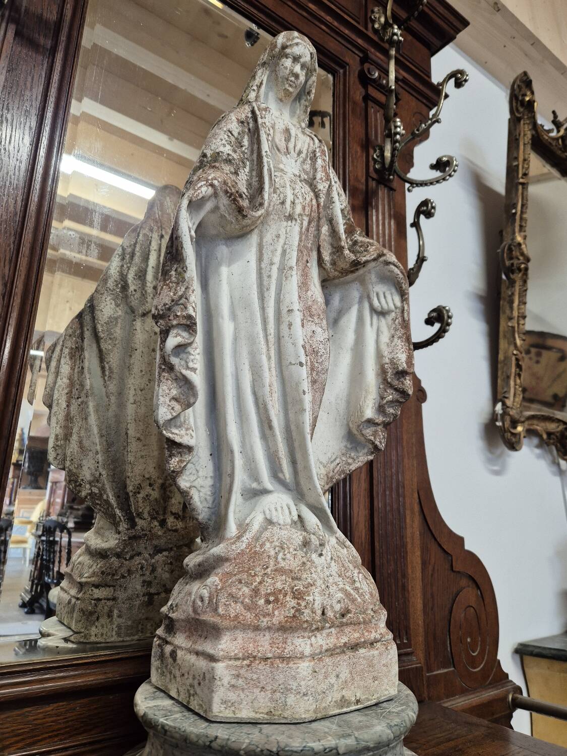 Garden statue of the Virgin Mary in old reconstituted stone