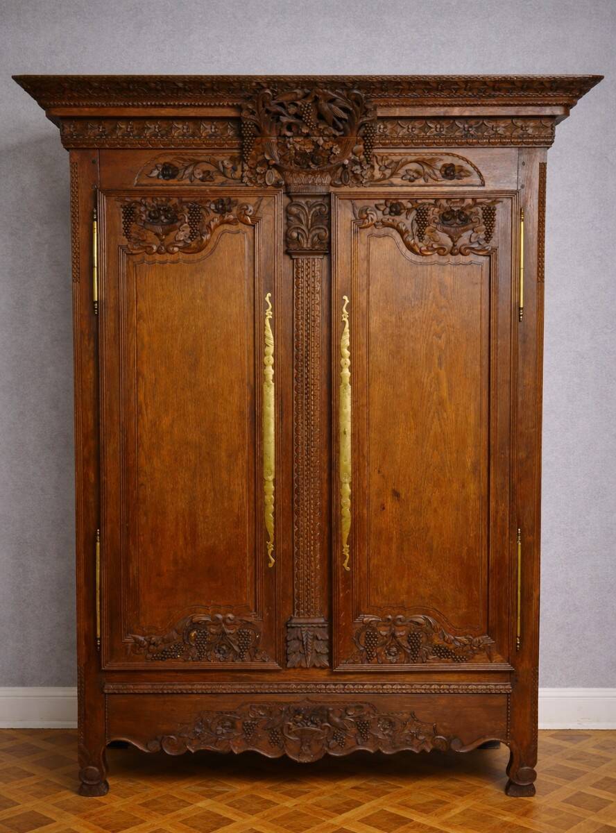 Norman Wedding Armoire in solid oak, richly carved, Louis period.