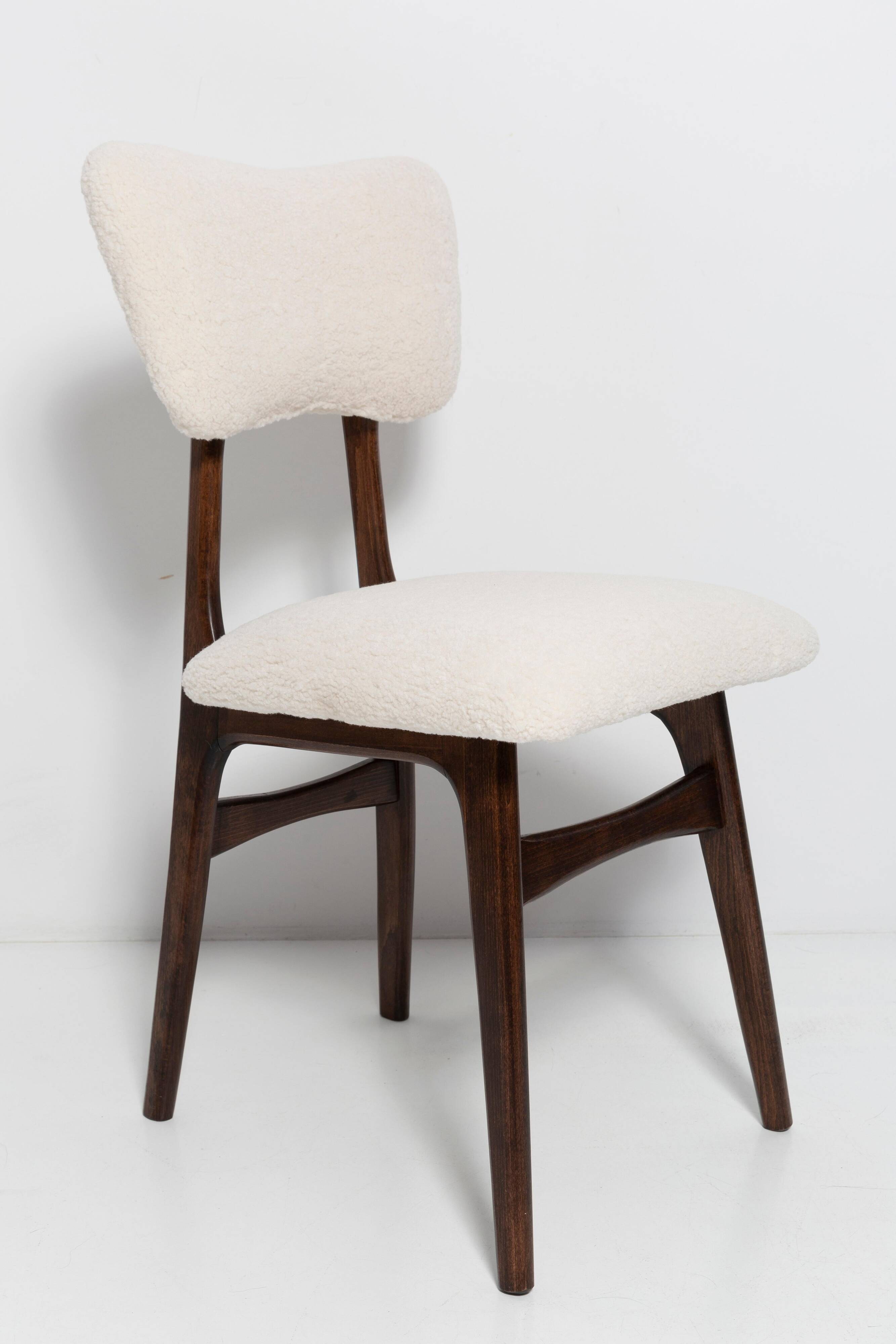 20th-century walnut and light cream boucle butterfly chair, Europe, 1960.