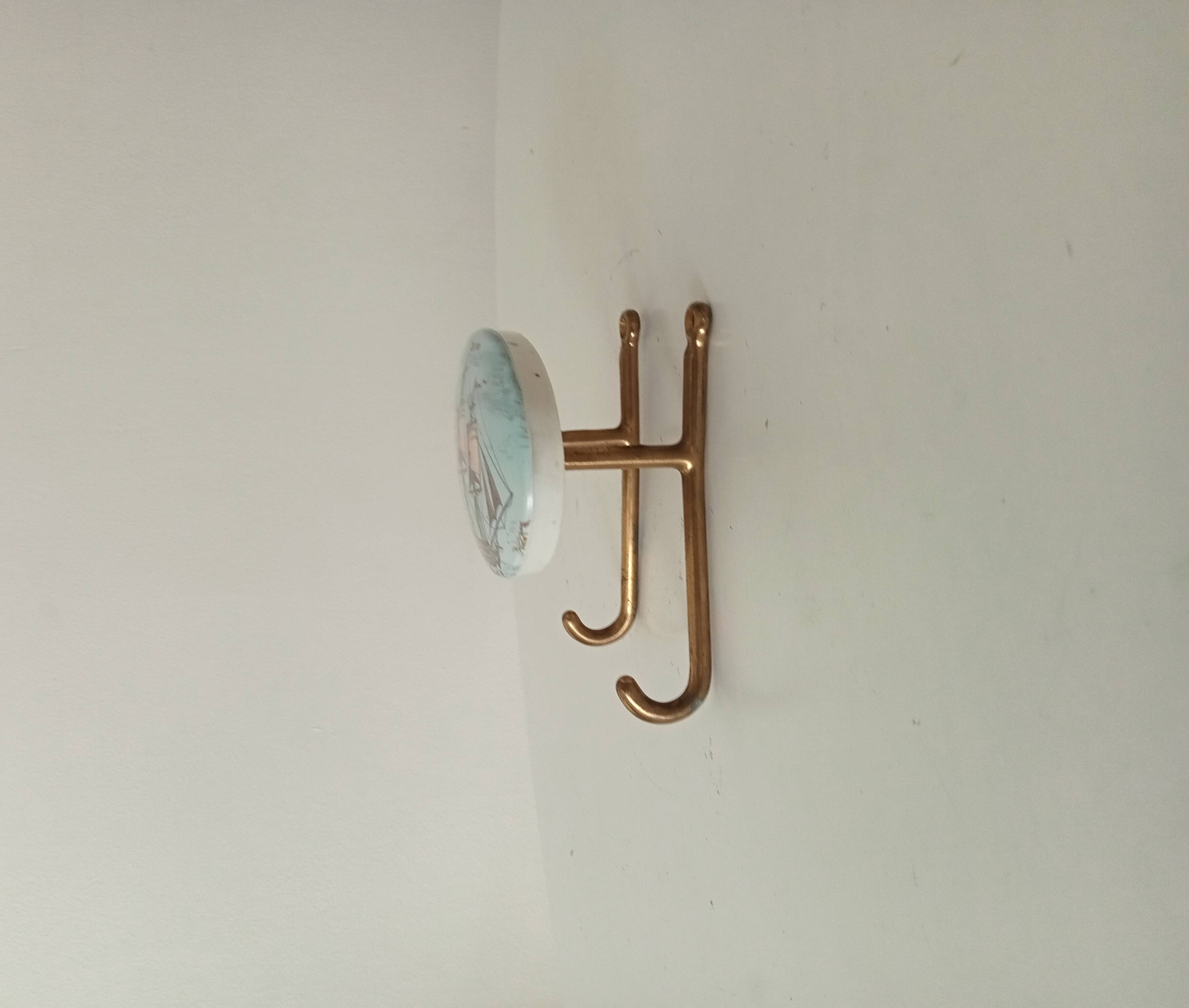 Vintage wall coat hook in brass and Bakelite.