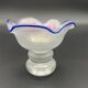 Eisch glass footed cup with pearlescent finish, blue rim.