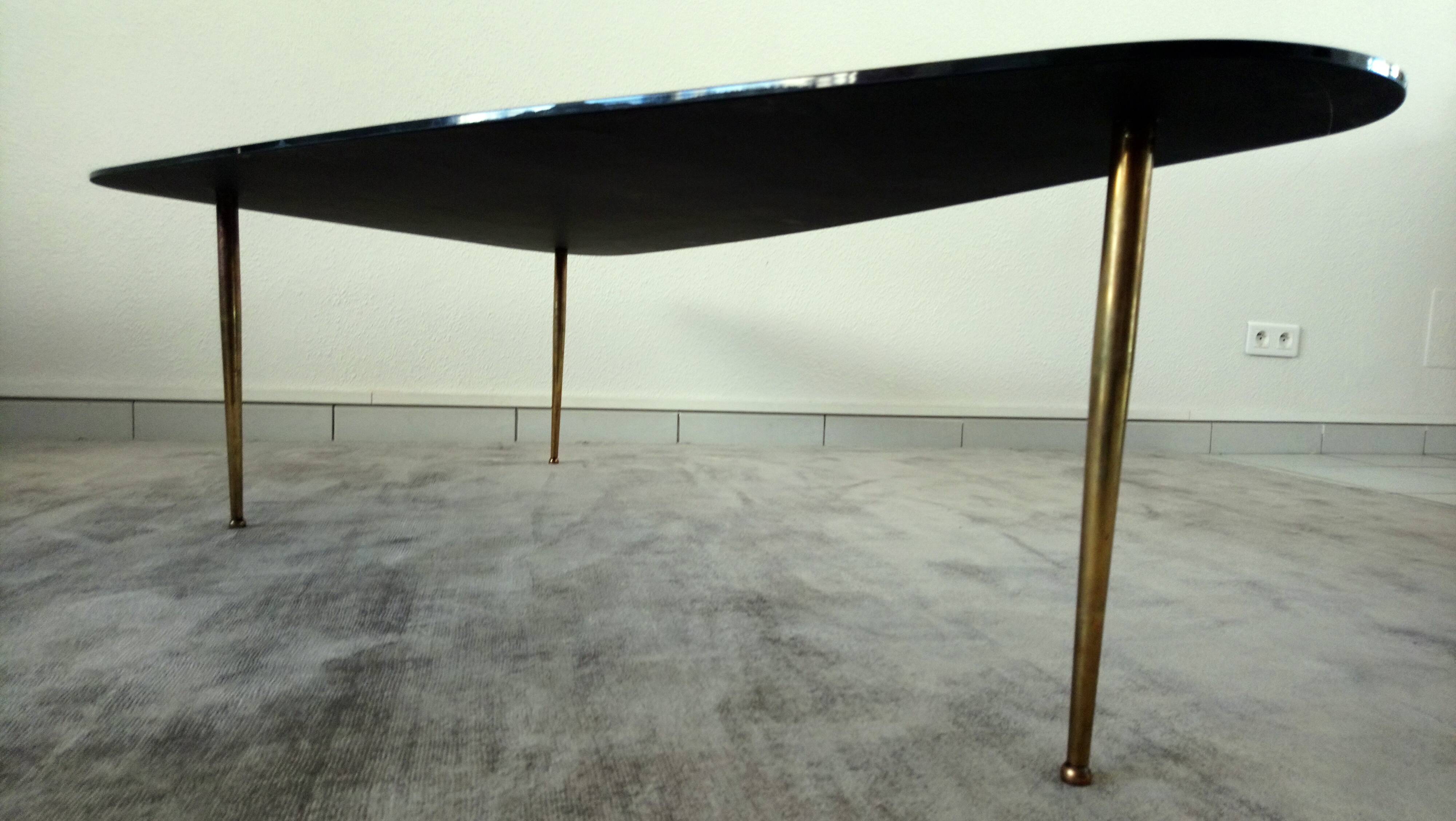 Tripod vintage black glass coffee table