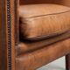 Sheepskin club armchair with a cognac colour finished with decorative nails