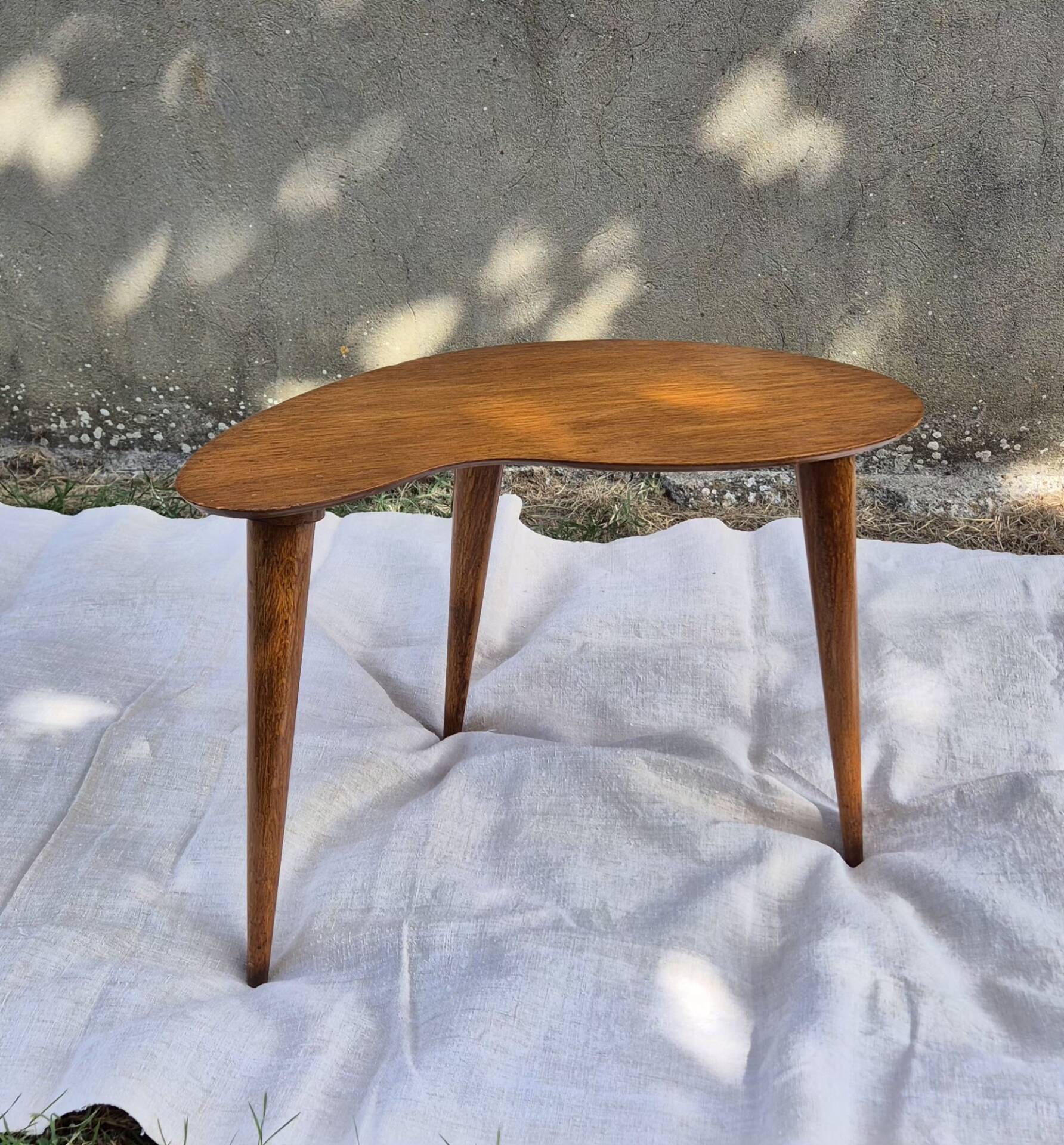 Vintage Scandinavian bean side table with wooden tapered legs.