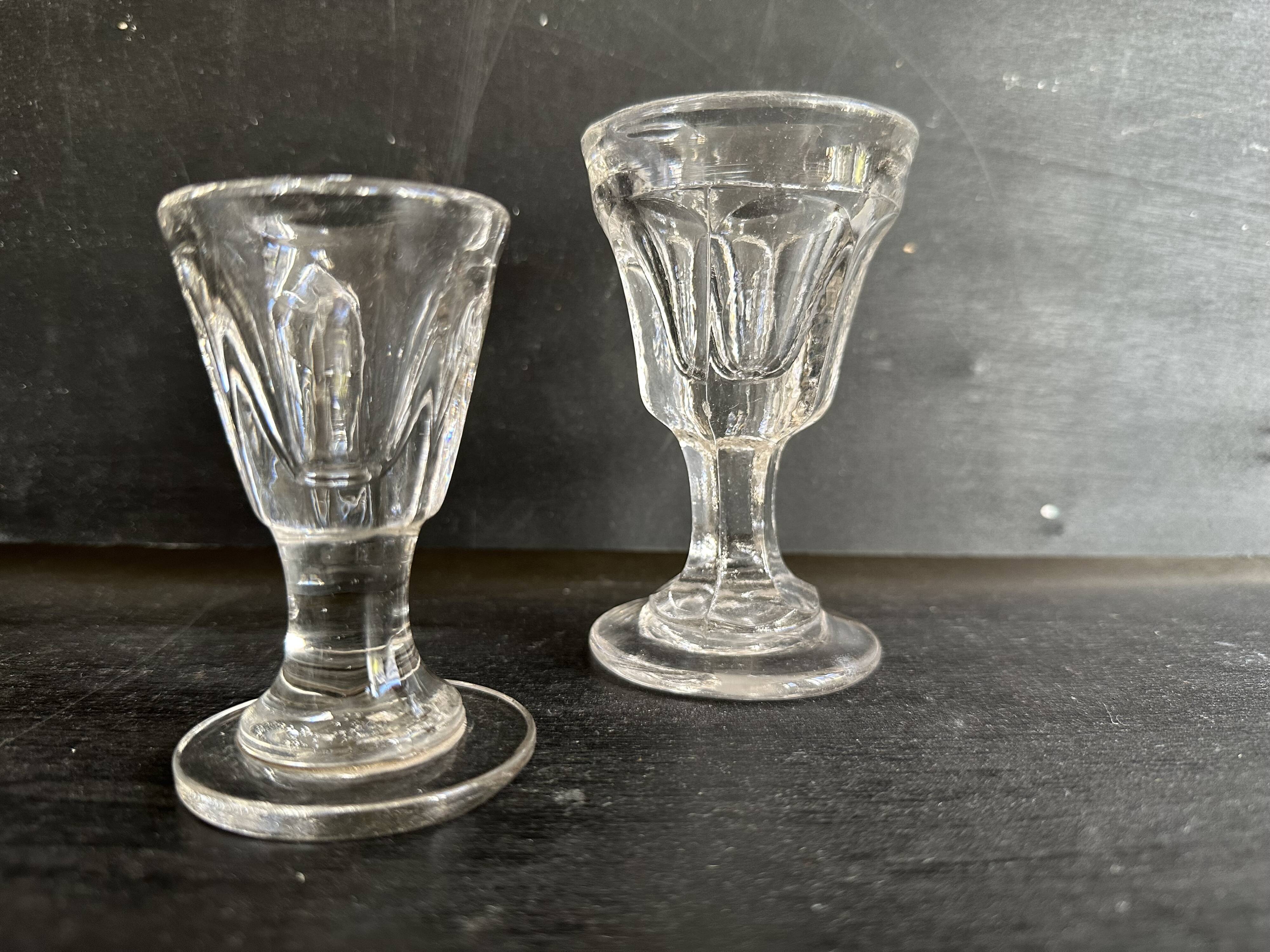 Set of antique liqueur glasses in thick glass, bistro style.