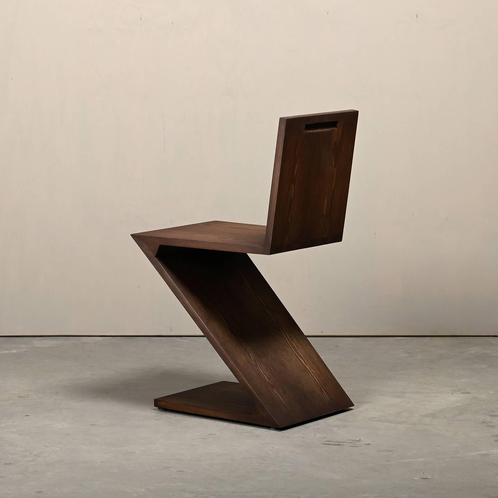 Gerrit Rietveld Zig Zag Chair is dark brown stained wood