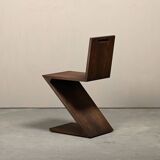 Gerrit Rietveld Zig Zag Chair is dark brown stained wood