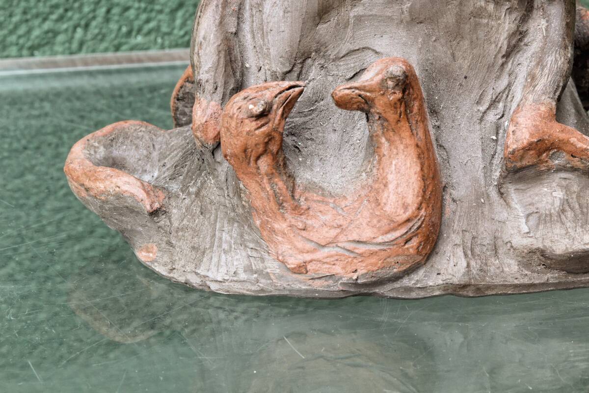 Lamp base in sculpted terracotta featuring birds, signed.