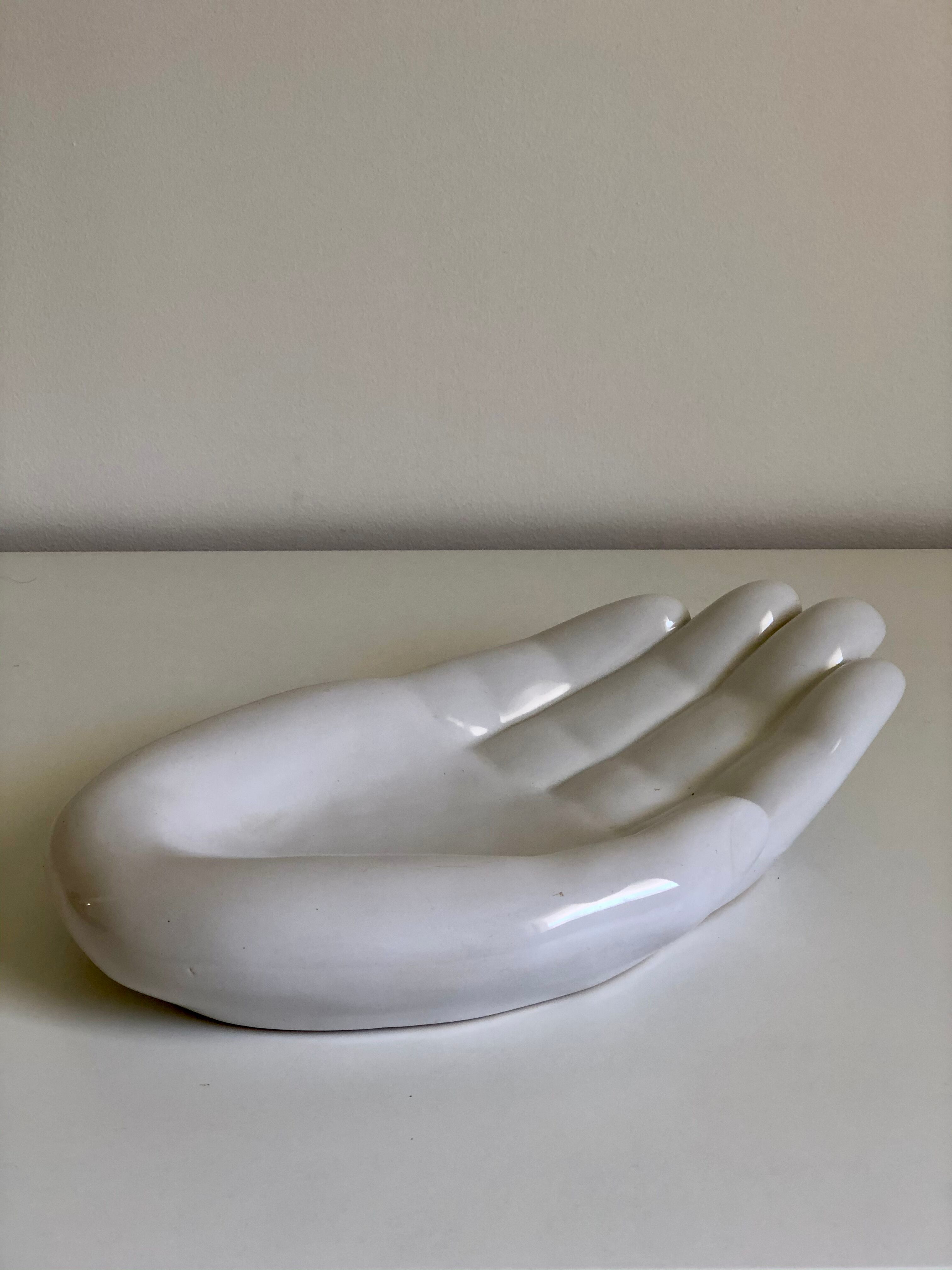 Empty white enamelled ceramic pocket in the shape of a large hand, 1990