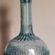 Blue glass carafe with vintage pegs
