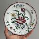 5 plates with colorful Sarreguemines floral designs.