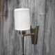 Brass wall light, black lacquered metal and white opal glass, 50s.