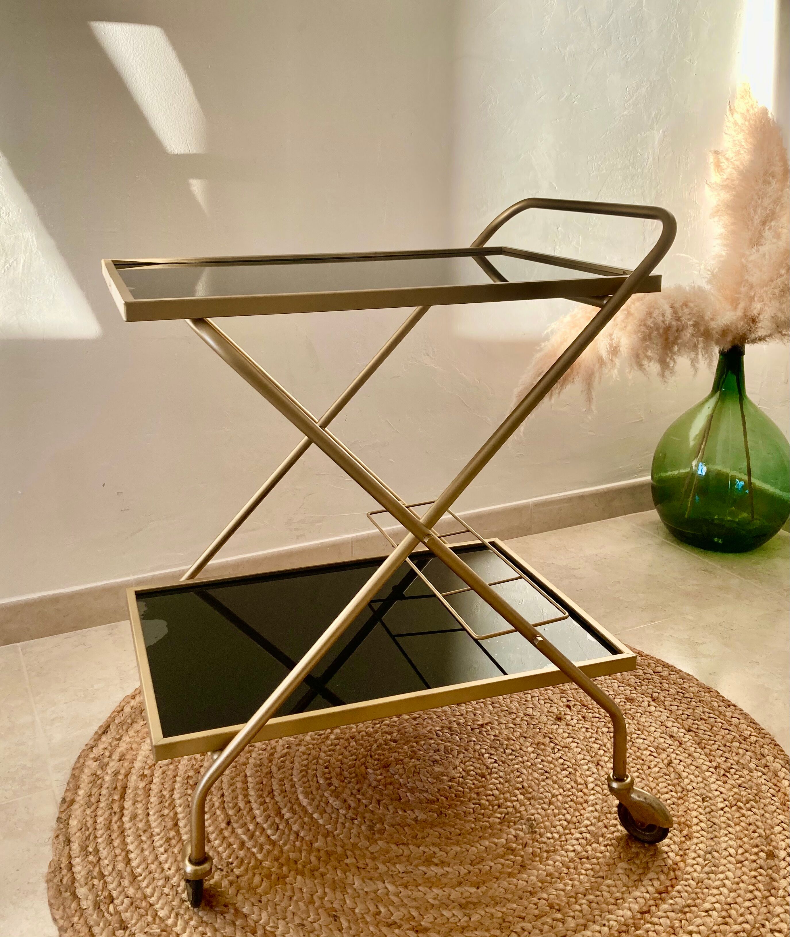 Golden dessert on wheels with black glass trays