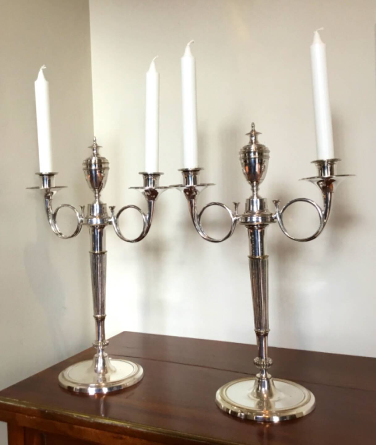 Pair of silver-plated metal candelabra decorated with hunting horns
